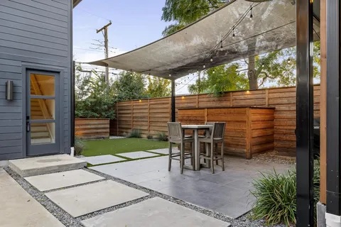 a patio with table and chairs