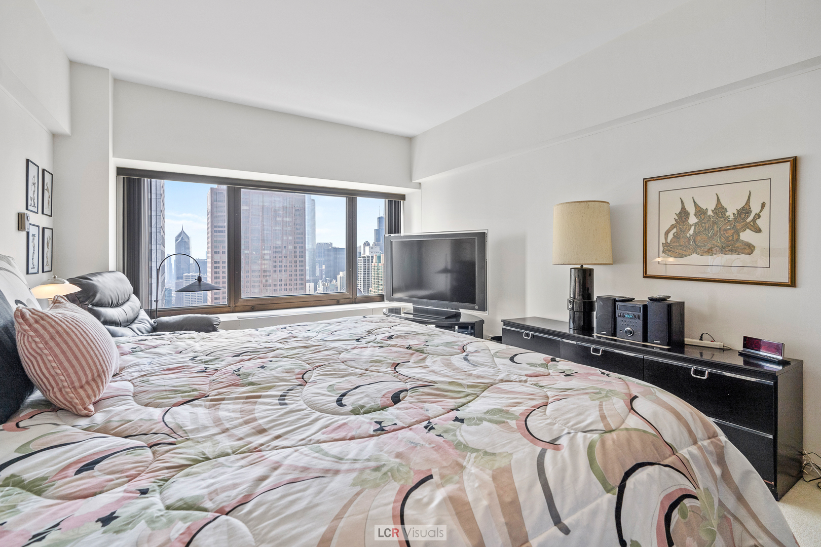175 East Delaware Place, Unit 4816 Chicago, IL 60611 - Photo 12 of 30 a bedroom with a bed and a flat screen tv