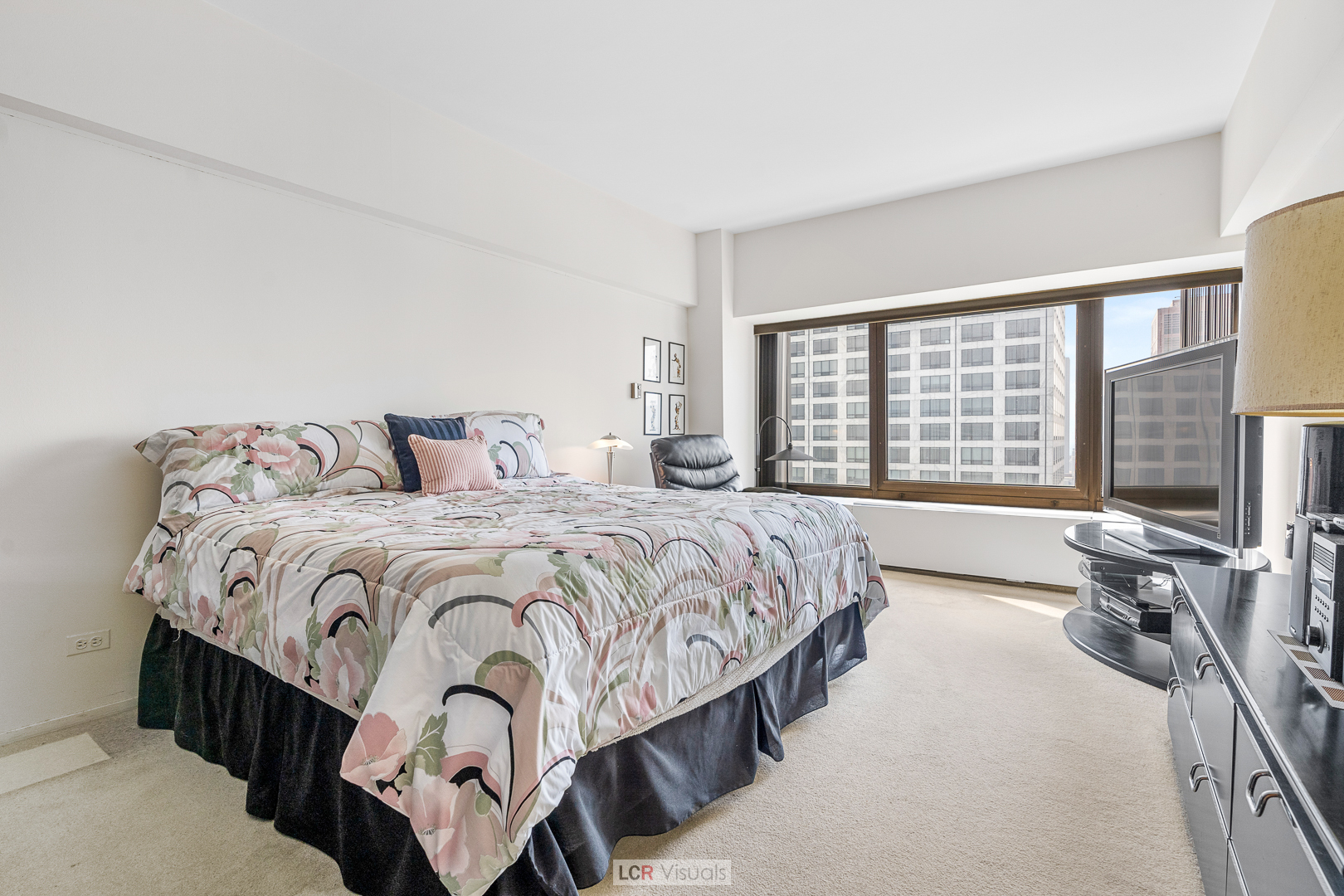 175 East Delaware Place, Unit 4816 Chicago, IL 60611 - Photo 13 of 30 a bedroom with a bed a table and large windows