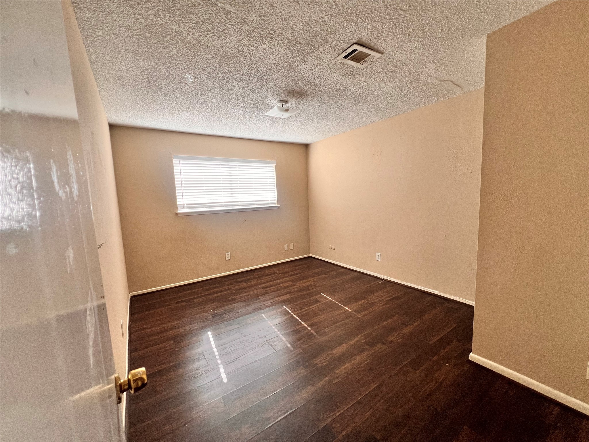 6331 Pouter Drive Houston, TX 77083 - Photo 18 of 28 an empty room with wooden floor and windows