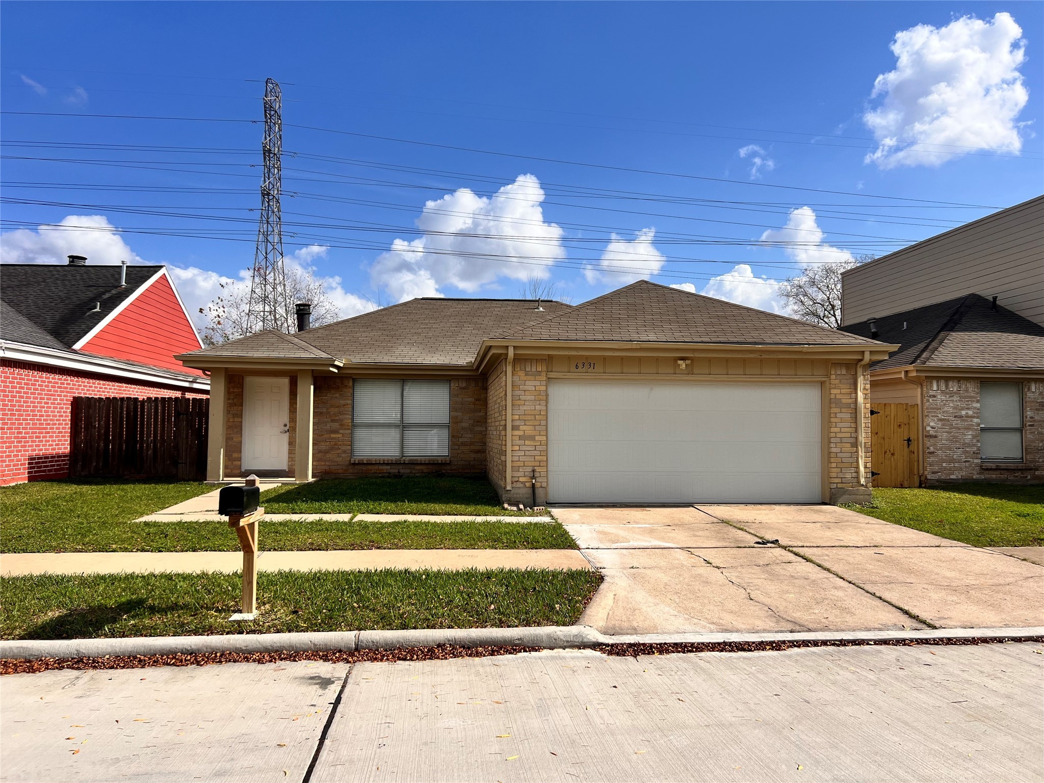 6331 Pouter Drive Houston, TX 77083 - Photo 2 of 28 a front view of a house with a yard and garage