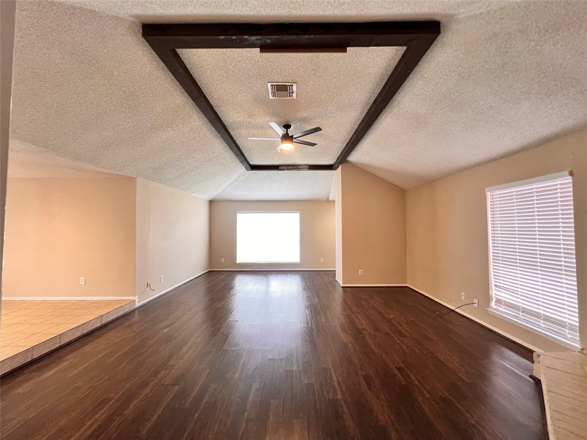 6331 Pouter Drive Houston, TX 77083 - Photo 5 of 28 a view of an empty room with wooden floor and a window