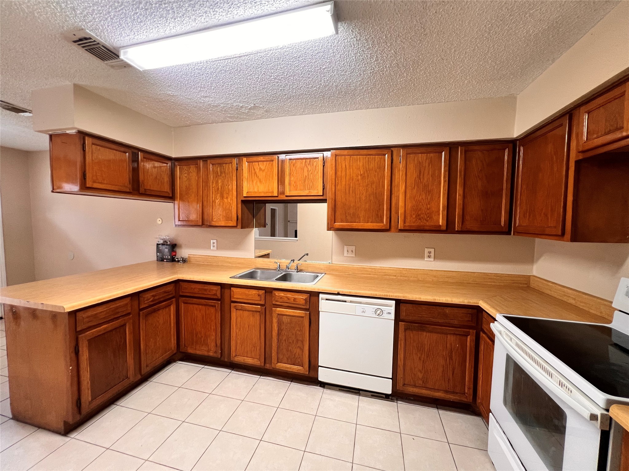 6331 Pouter Drive Houston, TX 77083 - Photo 10 of 28 a kitchen with a sink stove top oven and cabinets