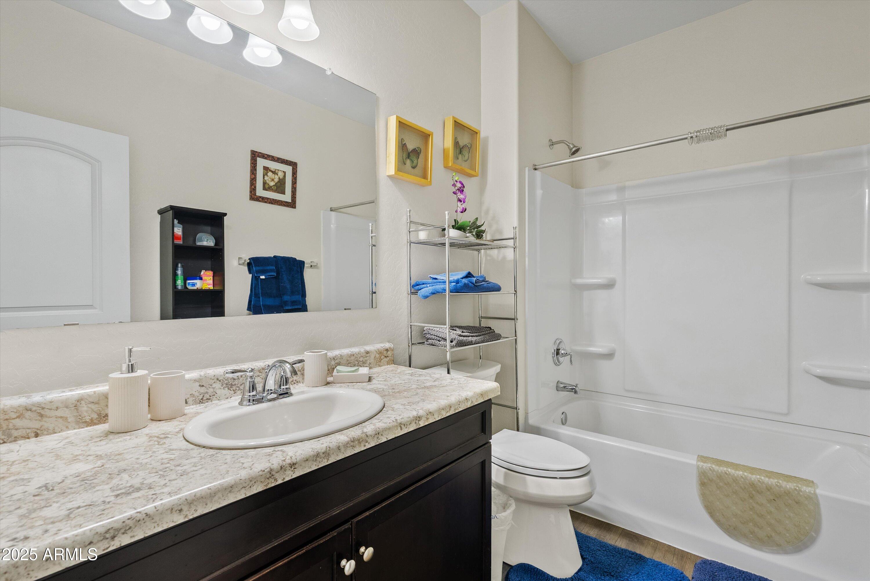 4708 South 26th Lane Phoenix, AZ 85041 - Photo 12 of 23 a bathroom with a granite countertop sink toilet and shower