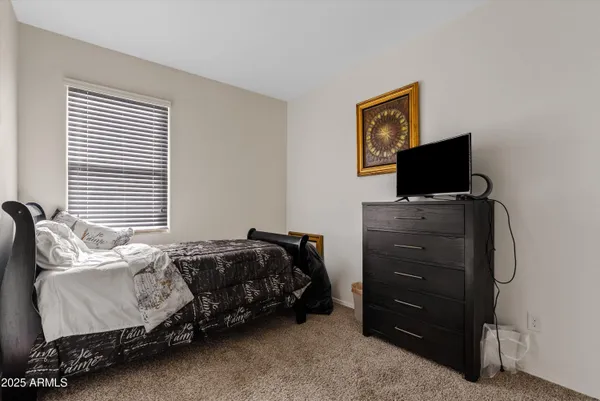 a bedroom with a bed and television