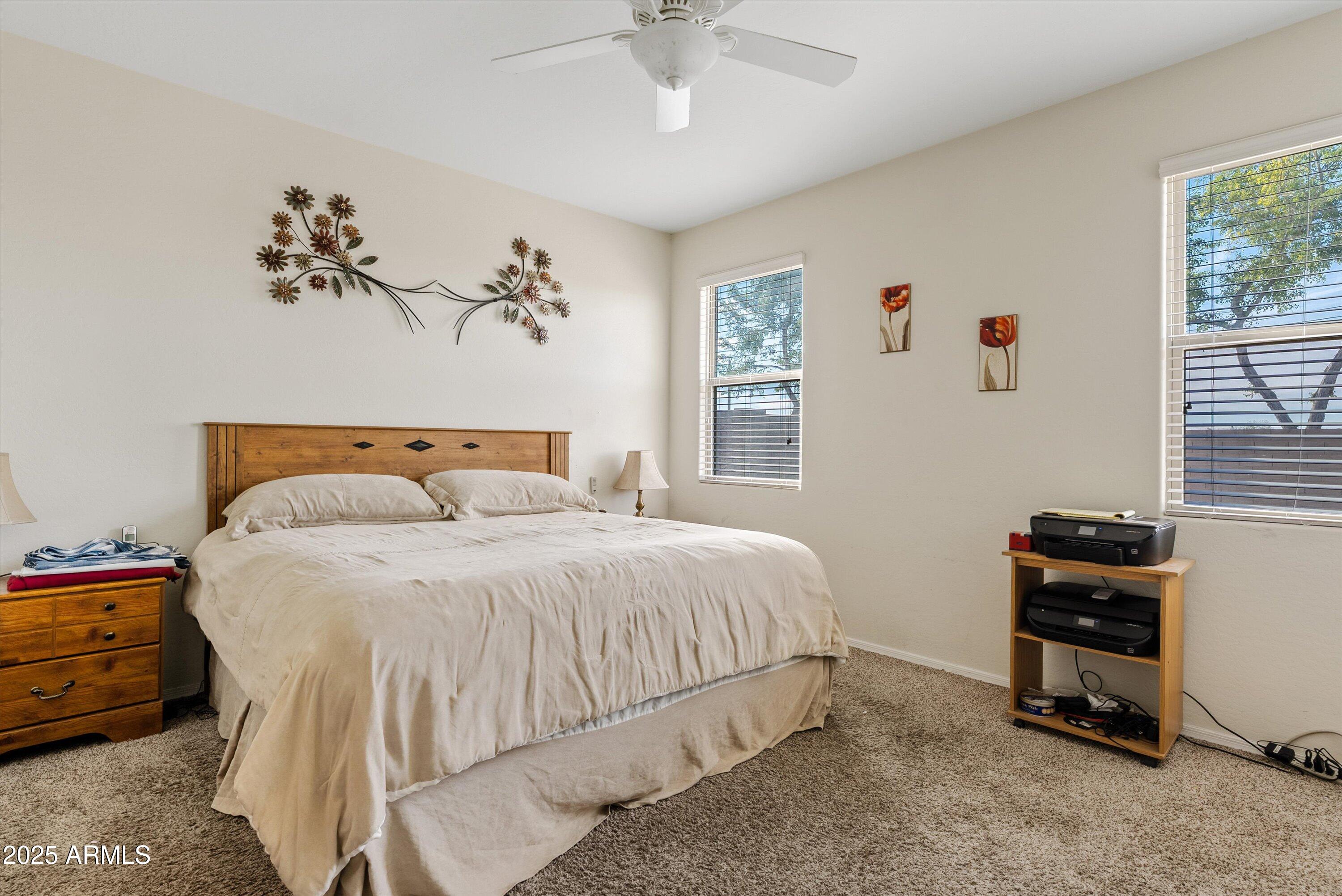 4708 South 26th Lane Phoenix, AZ 85041 - Photo 17 of 23 a bedroom with a bed and a chandelier
