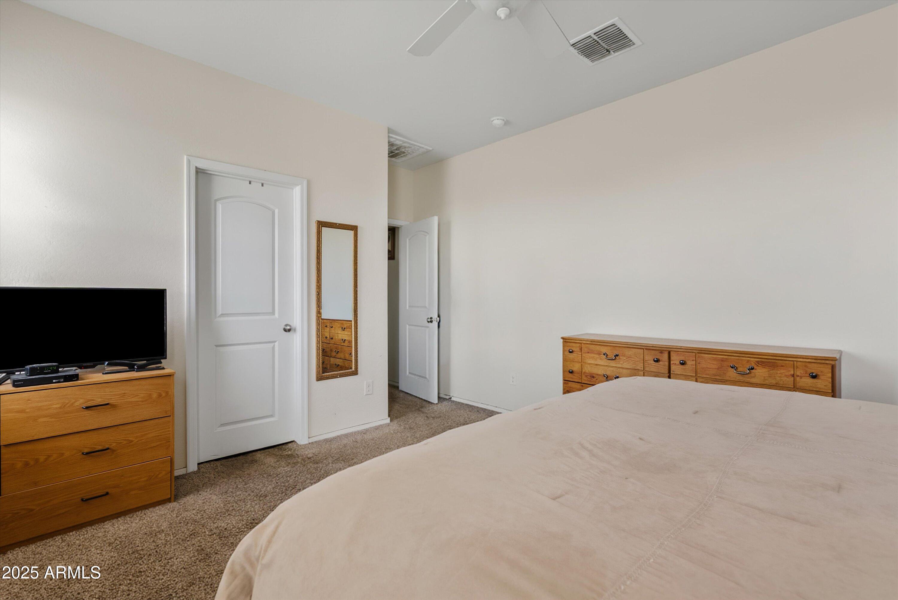 4708 South 26th Lane Phoenix, AZ 85041 - Photo 18 of 23 a bedroom with a bed and flat screen tv