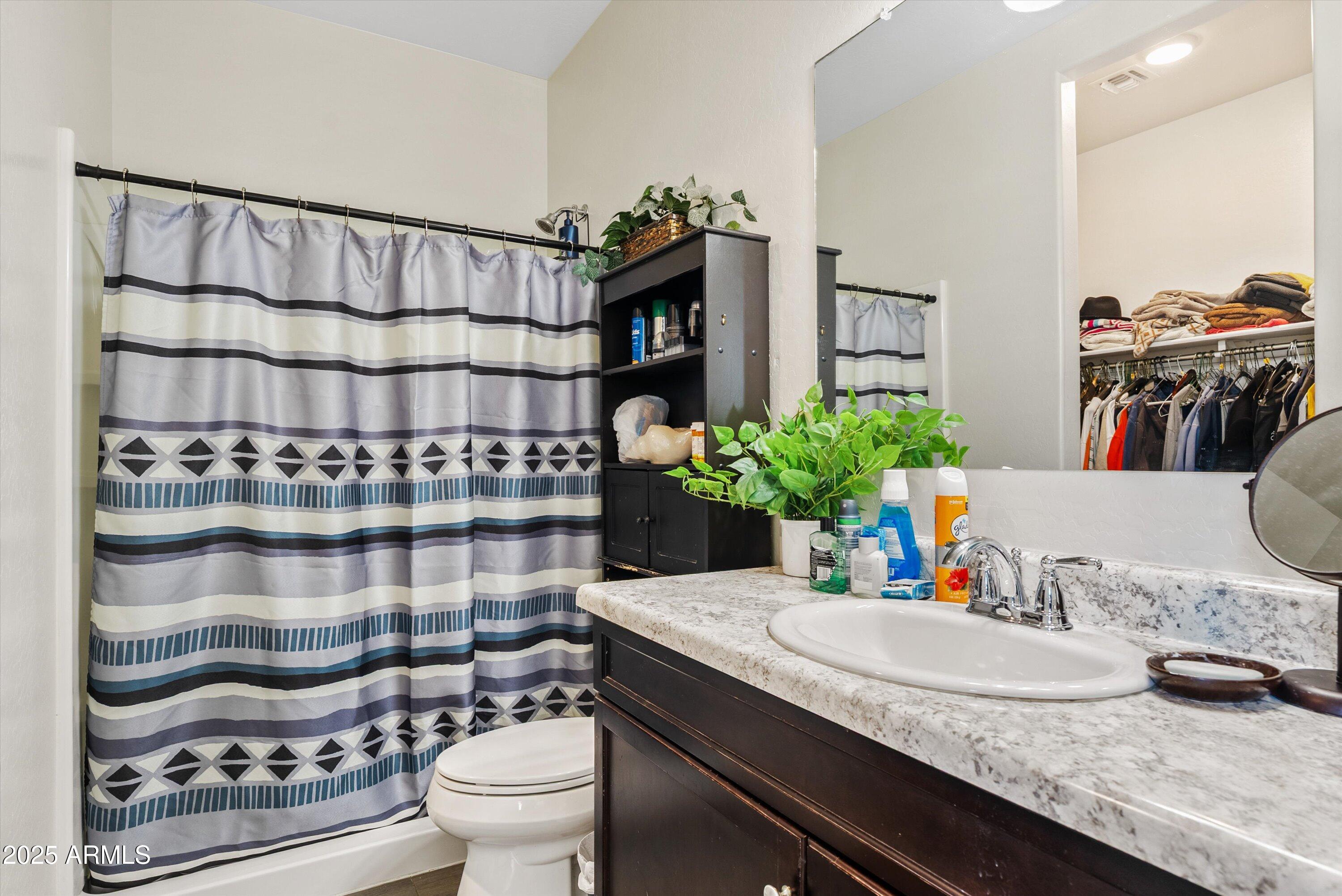4708 South 26th Lane Phoenix, AZ 85041 - Photo 19 of 23 a bathroom with a granite countertop sink and a toilet