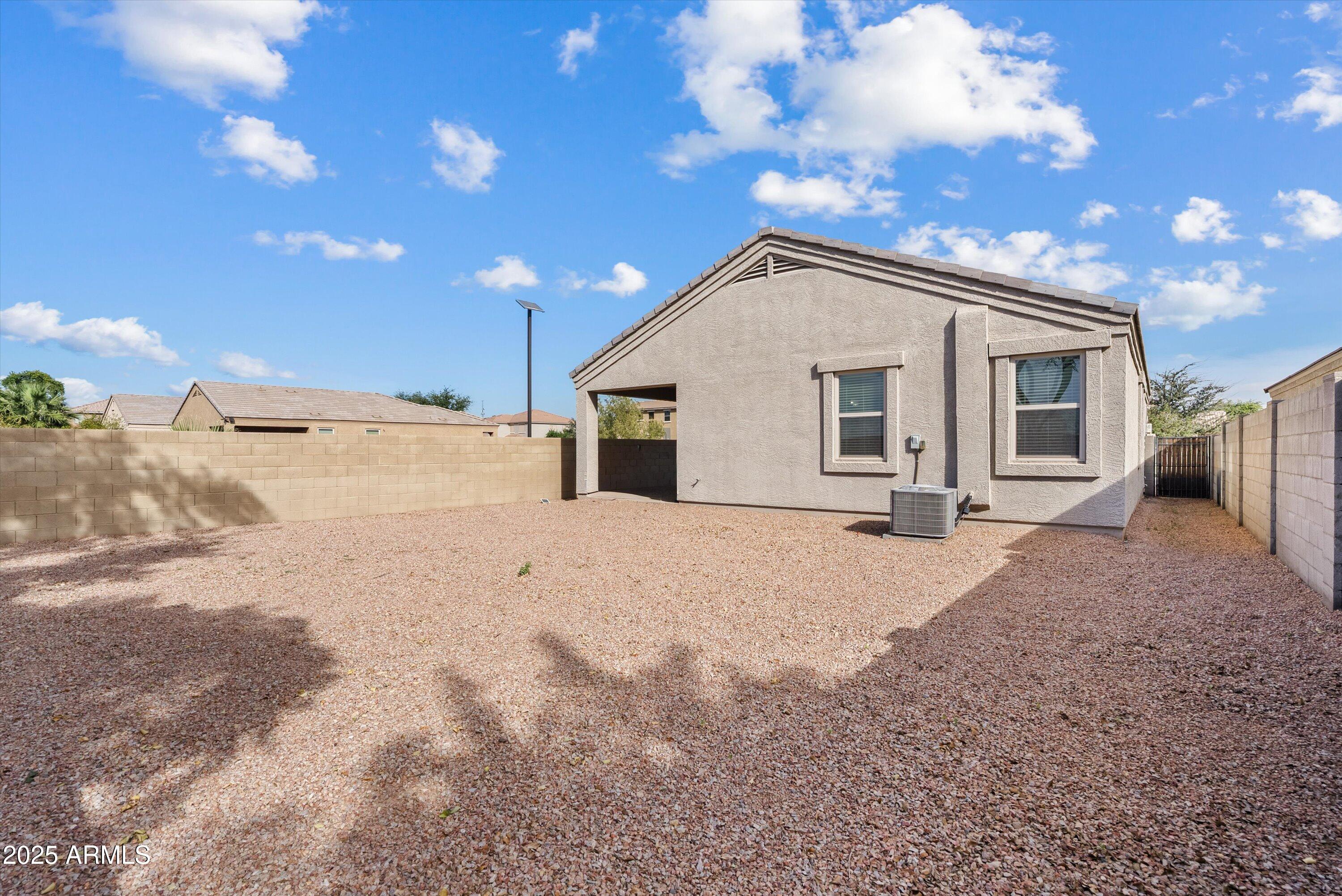 4708 South 26th Lane Phoenix, AZ 85041 - Photo 21 of 23 a view of a house with a snow in the yard