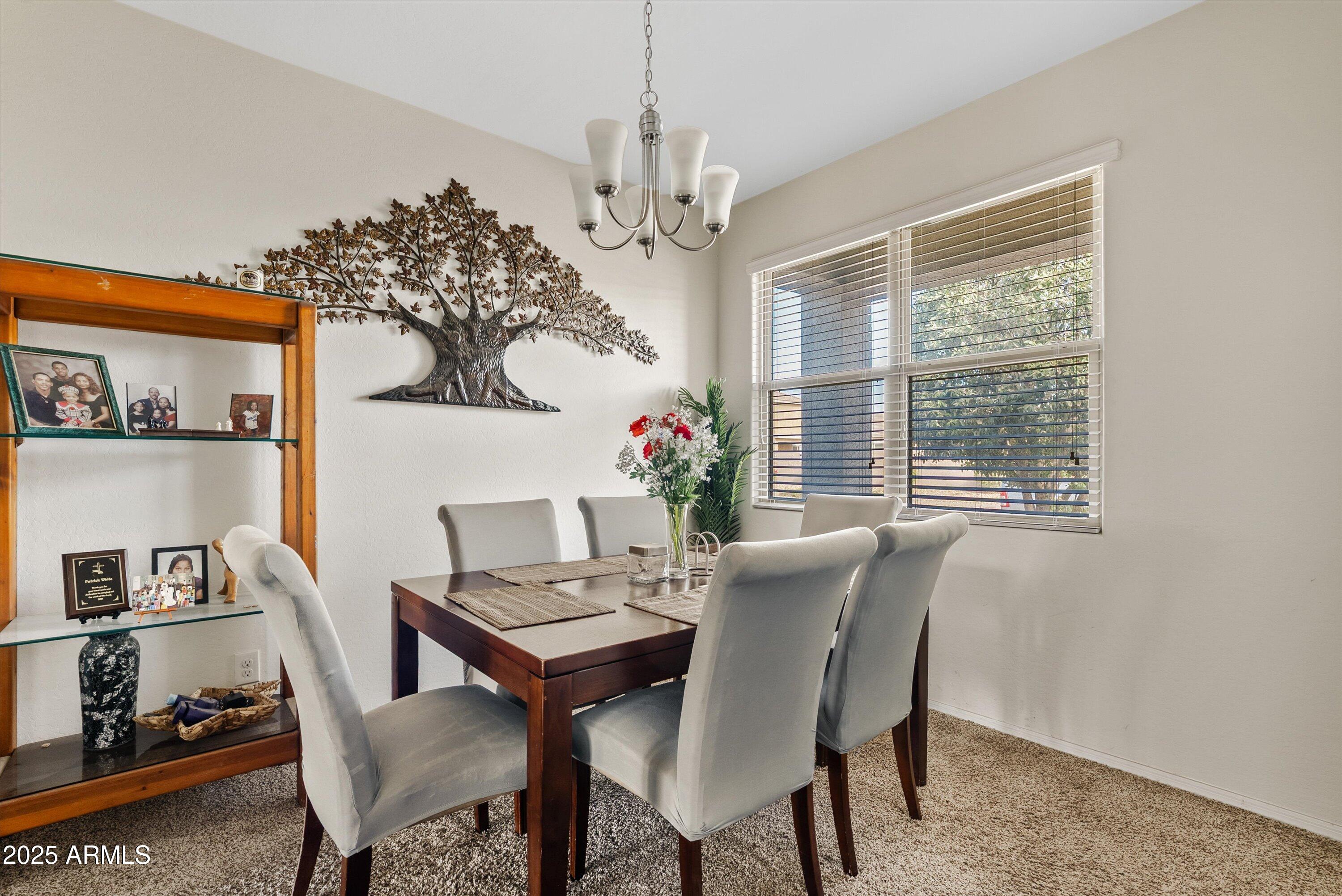 4708 South 26th Lane Phoenix, AZ 85041 - Photo 3 of 23 a view of a dining room with furniture window and wooden floor