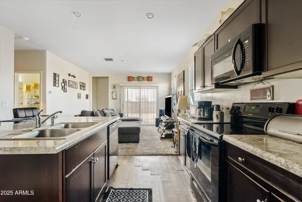 a kitchen with stainless steel appliances granite countertop a sink stove and cabinets