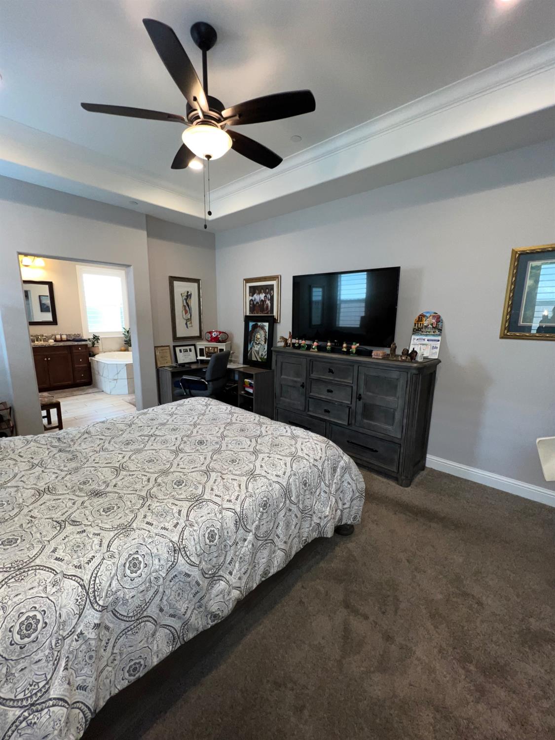 889 Coloma Place Madera, CA 93637 - Photo 35 of 61 a bed room with a bed a television and a large window