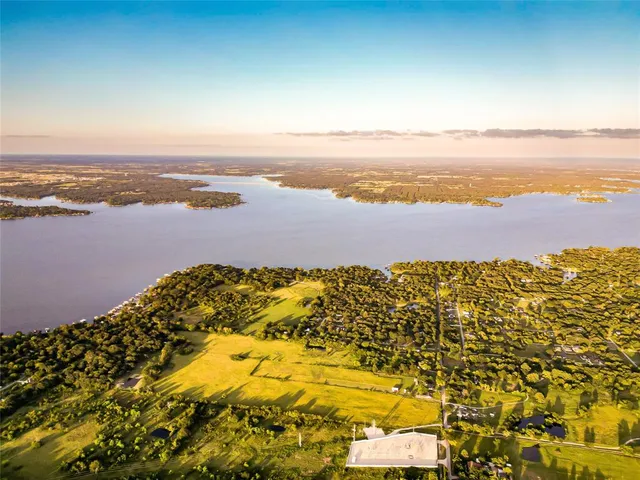 an aerial view of a houses with yard