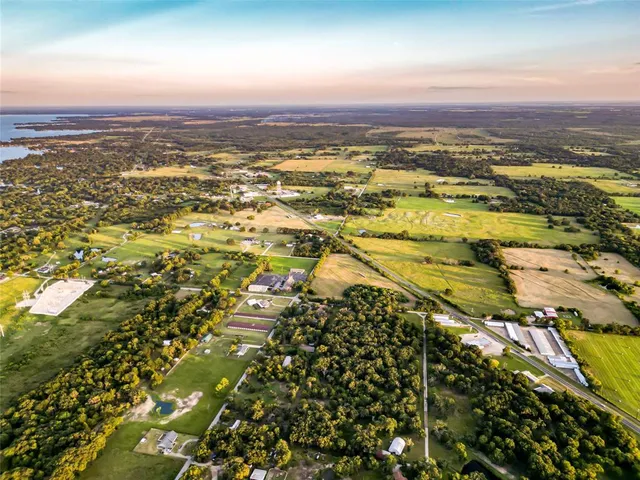 a view of a yard with a tree and a lake view