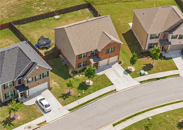 an aerial view of a house with swimming pool and ocean view