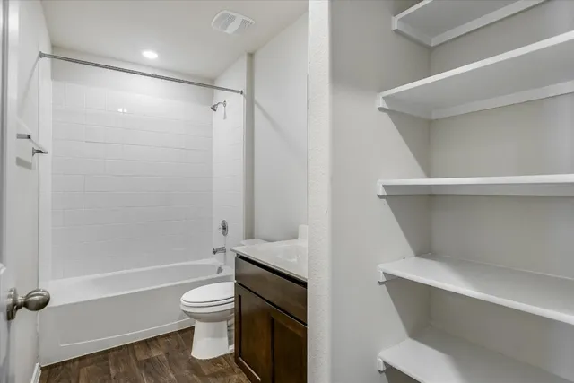 a bathroom with a toilet and a shower