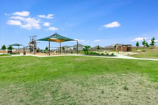 a view of a house with a yard and sitting area