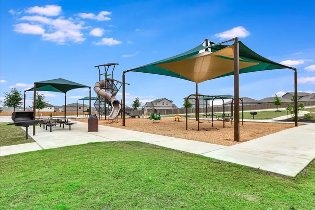 a view of a patio with a table and chairs under an umbrella