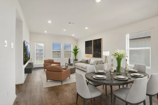 a living room with furniture potted plant and a window