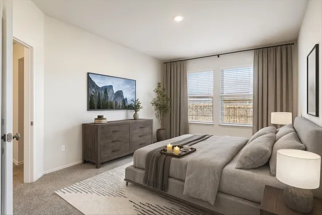 a bedroom with a bed and a dresser