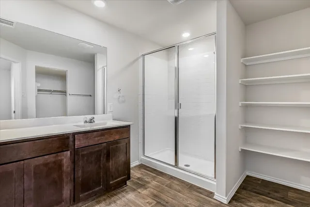 a bathroom with a double vanity sink and mirror