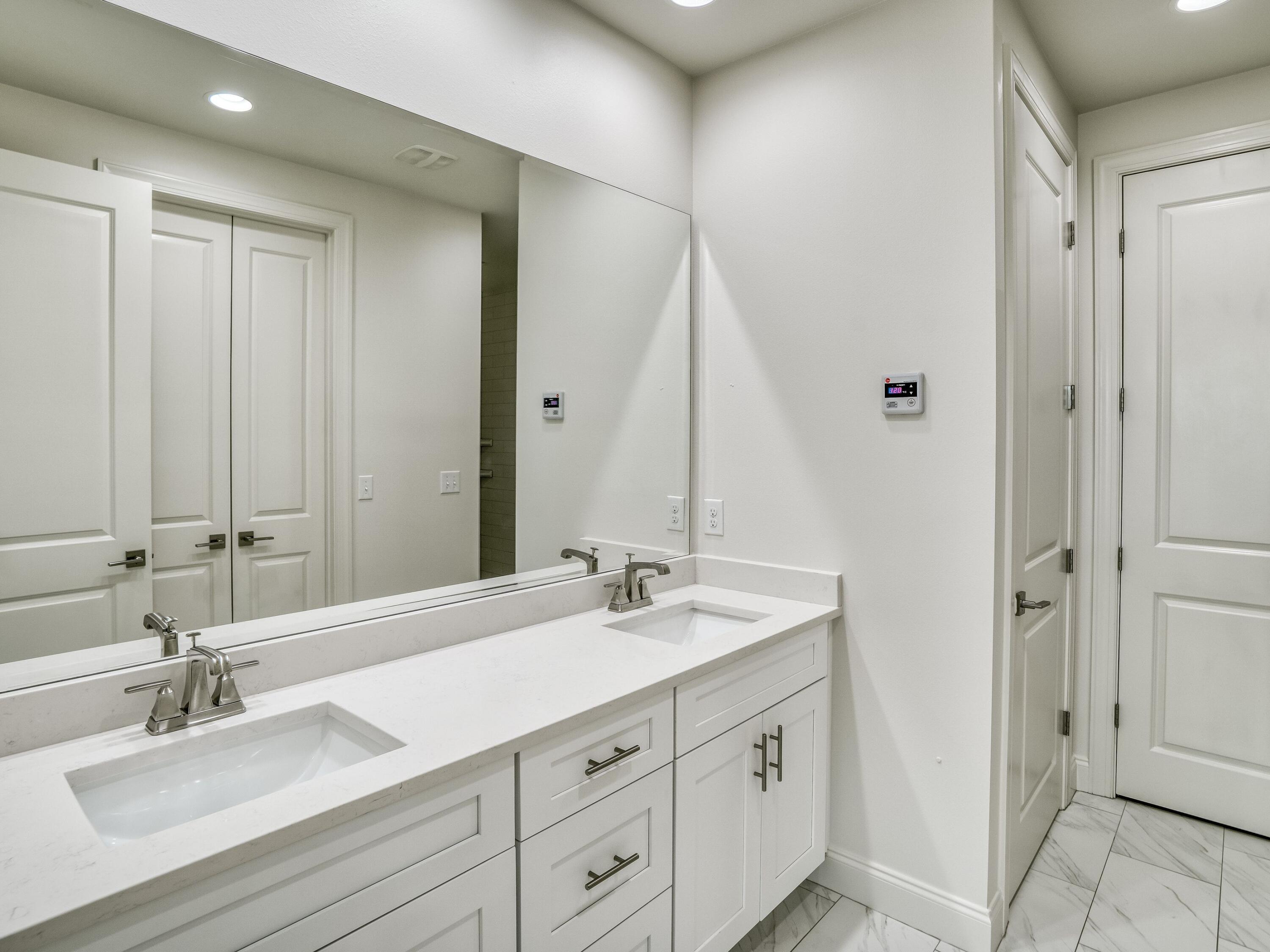 113 Conifer Court Watersound, FL 32461 - Photo 13 of 27 a bathroom with double vanity sink and a mirror