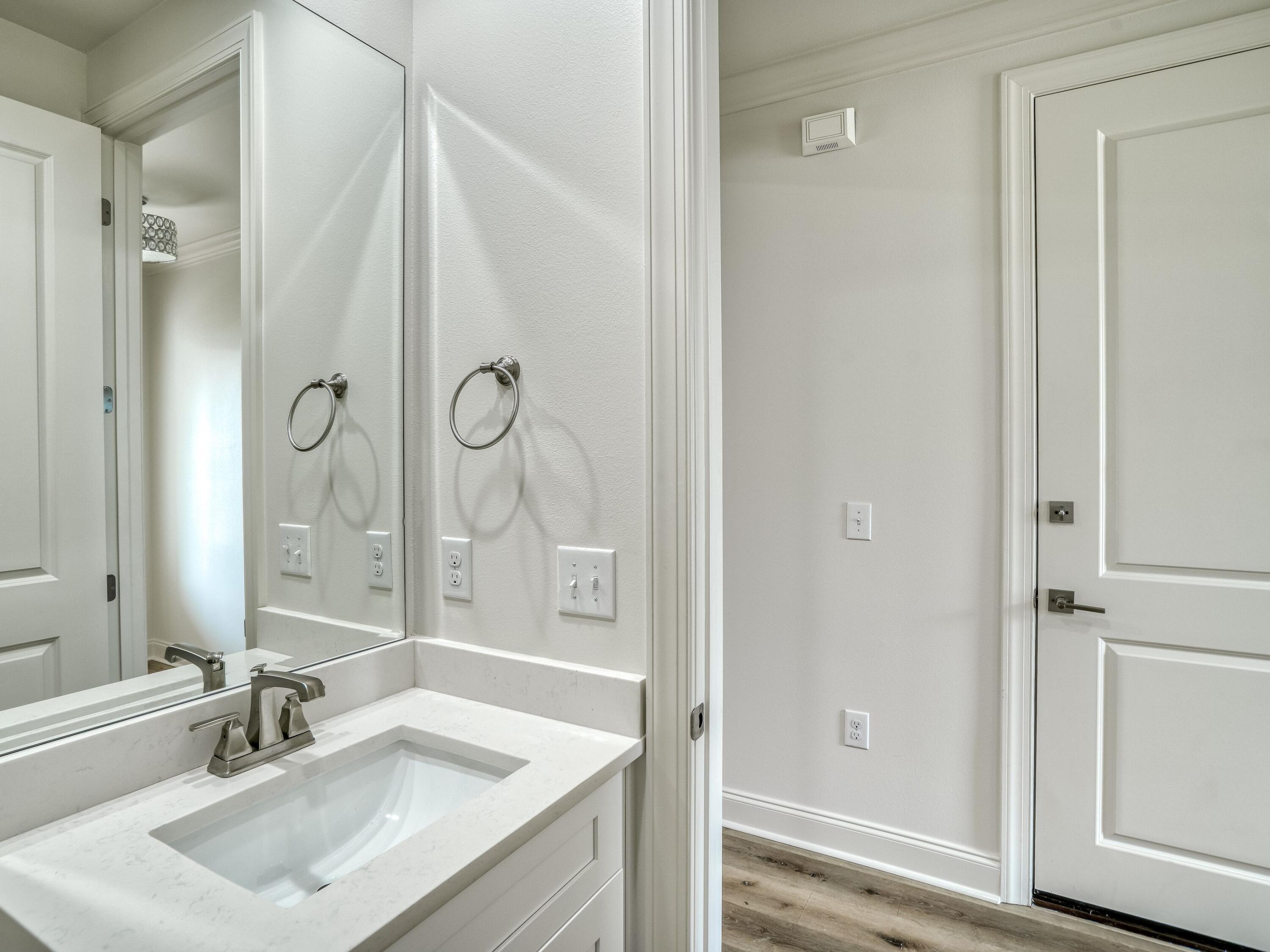 113 Conifer Court Watersound, FL 32461 - Photo 16 of 27 a bathroom with a sink vanity granite tub and shower