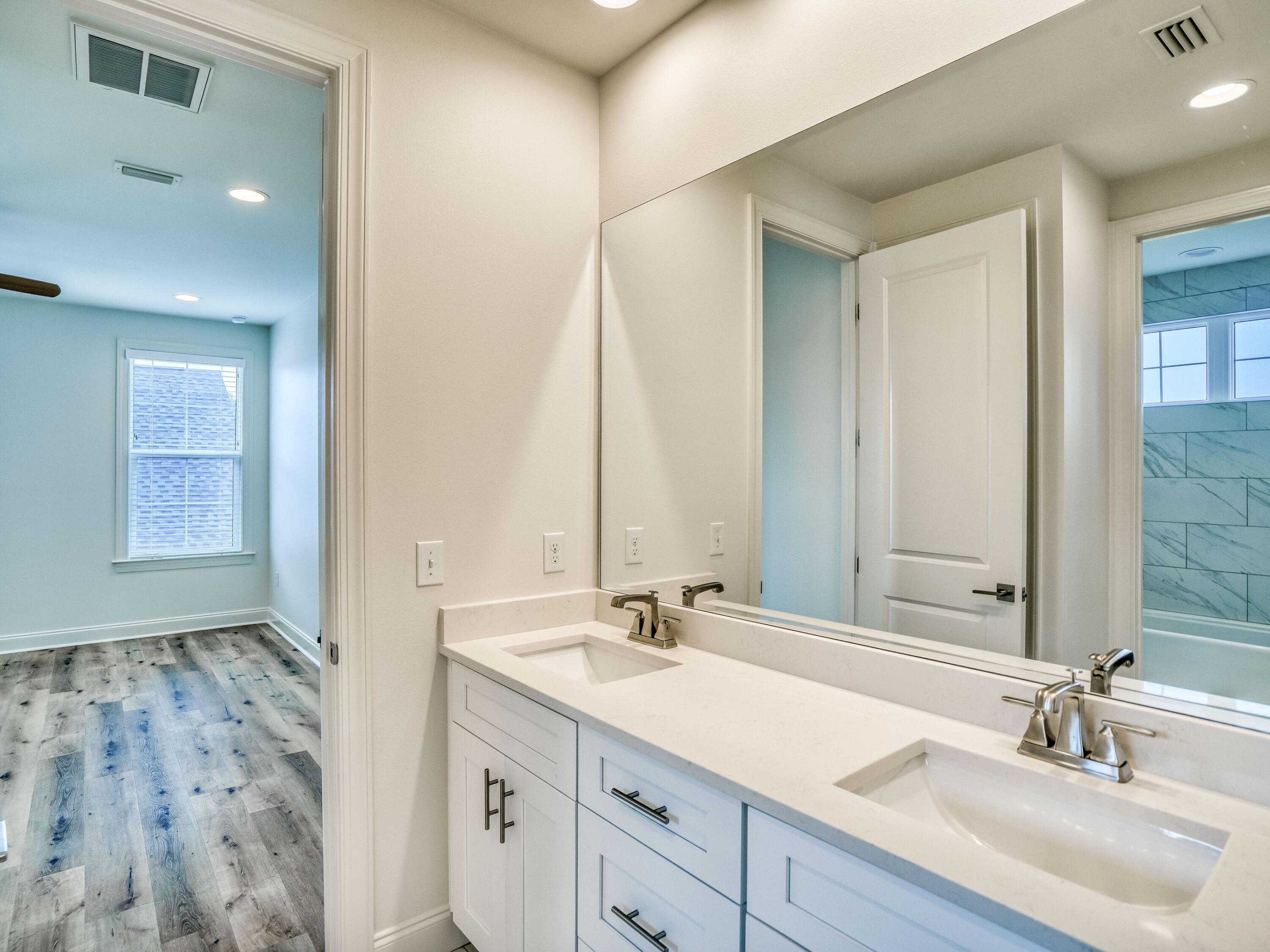 113 Conifer Court Watersound, FL 32461 - Photo 19 of 27 a bathroom with a sink and a mirror