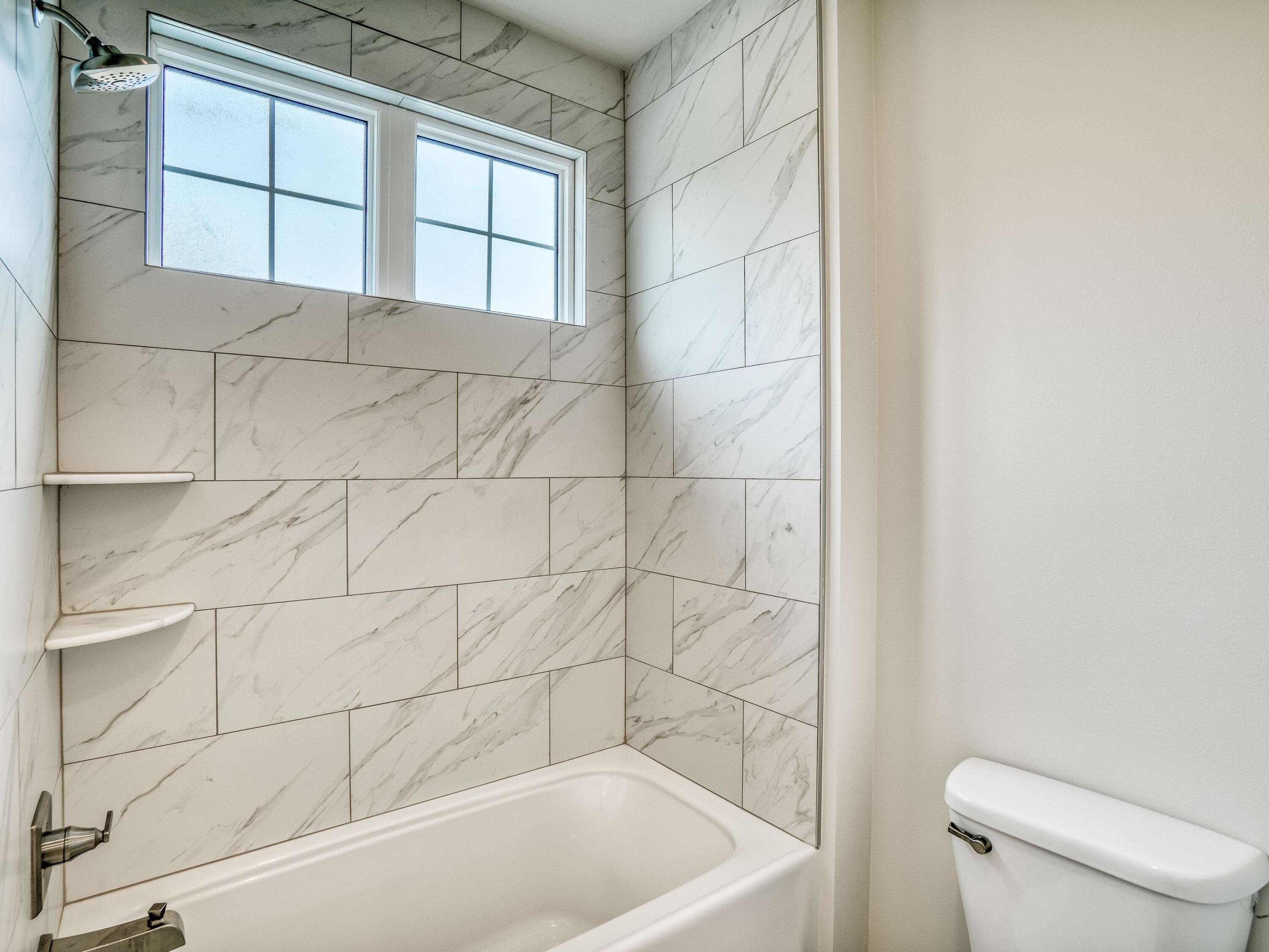 113 Conifer Court Watersound, FL 32461 - Photo 20 of 27 a bathroom with a bathtub and toilet