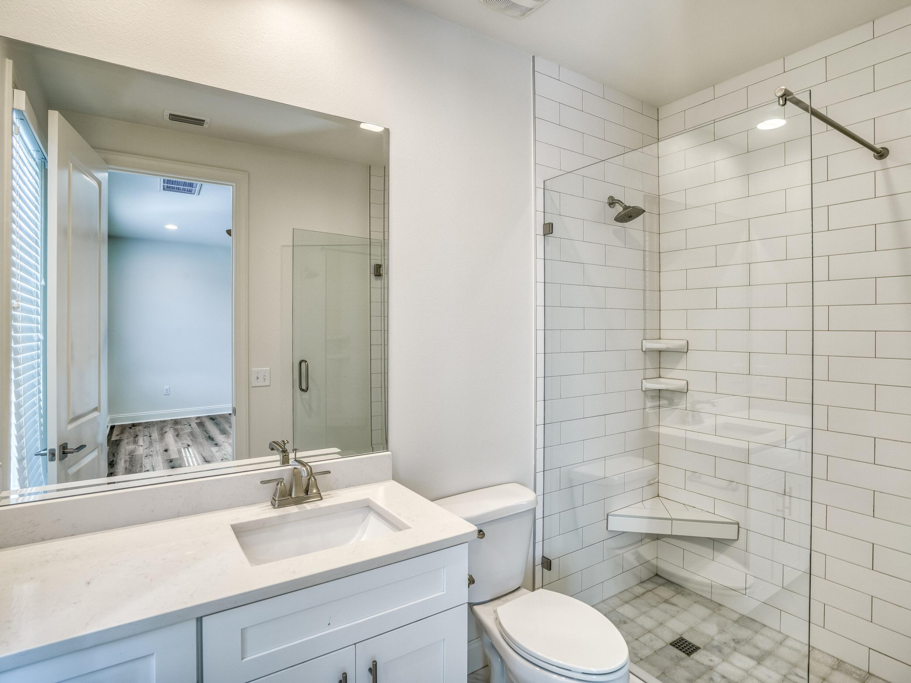 113 Conifer Court Watersound, FL 32461 - Photo 24 of 27 a bathroom with a sink toilet and shower