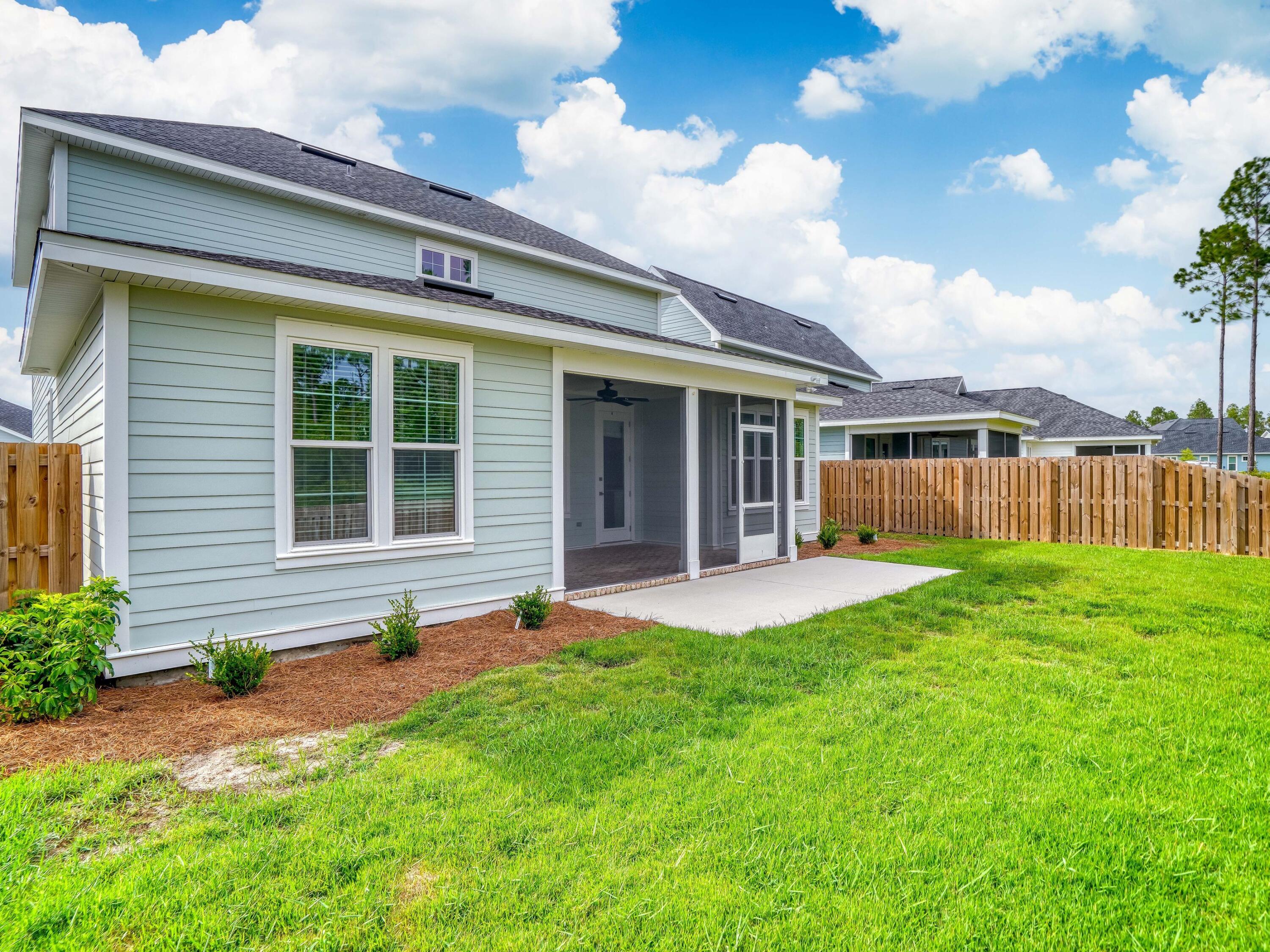 113 Conifer Court Watersound, FL 32461 - Photo 26 of 27 a view of a house with backyard and porch