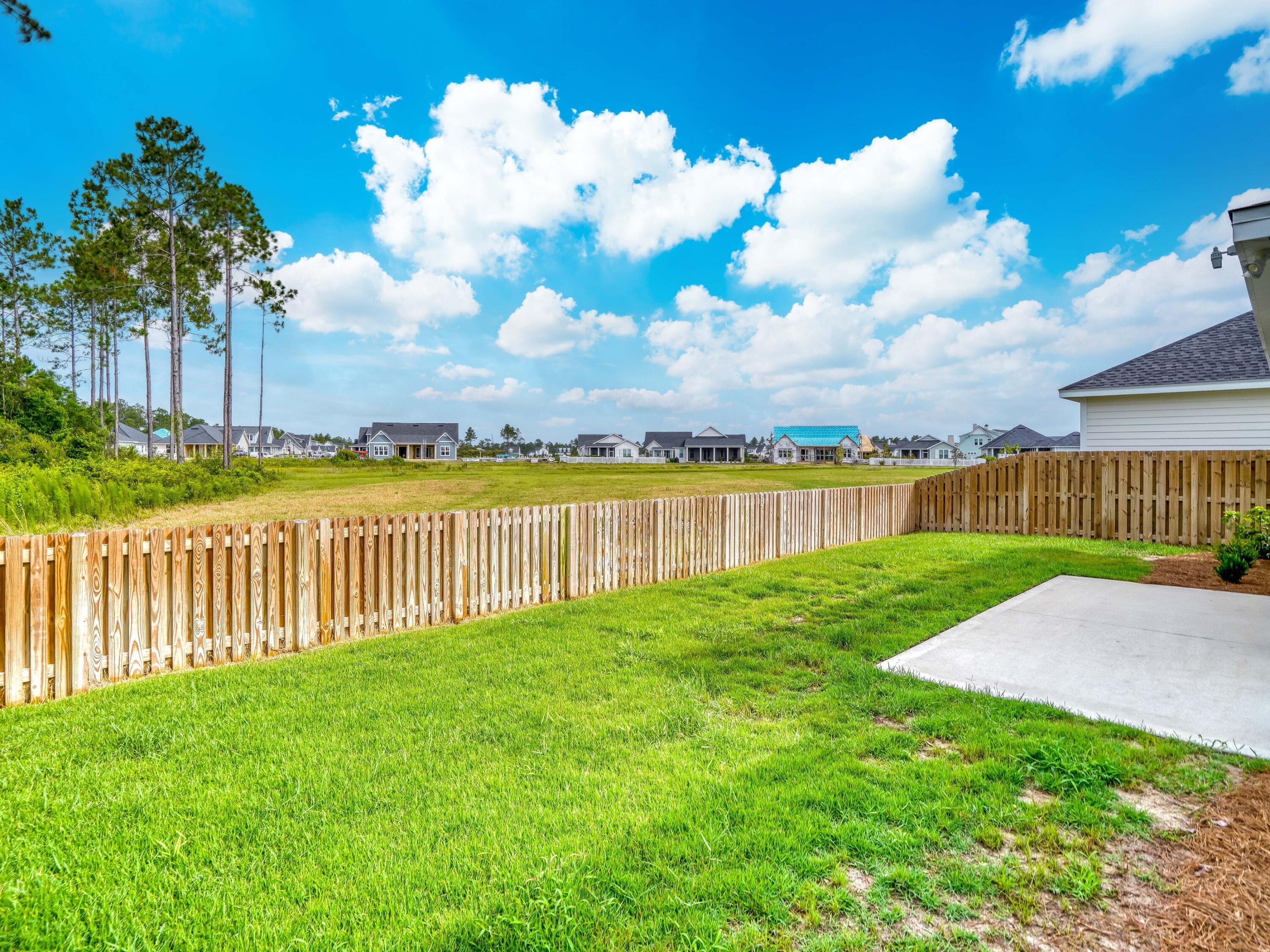 113 Conifer Court Watersound, FL 32461 - Photo 27 of 27 a view of a house with a yard and a garden
