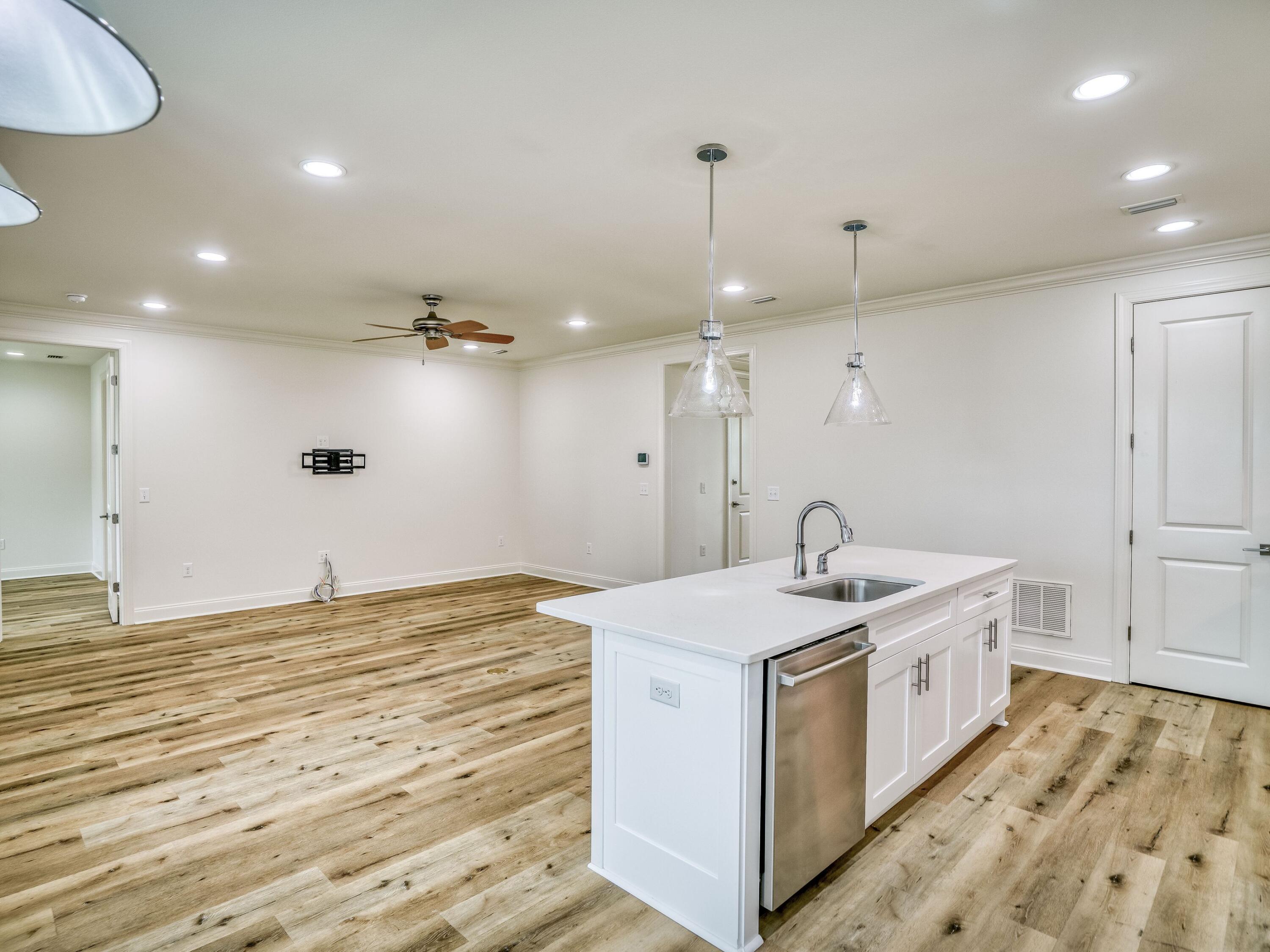 113 Conifer Court Watersound, FL 32461 - Photo 6 of 27 a kitchen with a stove and a sink