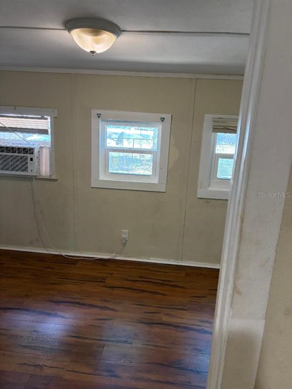 1623 Southeast 3rd Avenue Gainesville, FL 32641 - Photo 16 of 17 an empty room with wooden floor and windows
