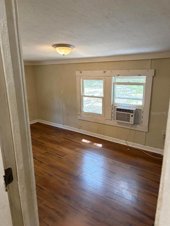 1623 Southeast 3rd Avenue Gainesville, FL 32641 - Photo 8 of 17 an empty room with wooden floor and windows
