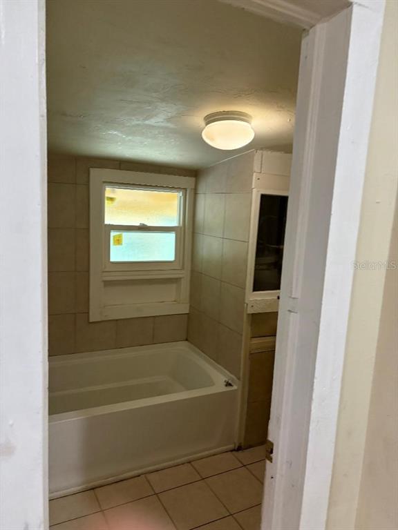 1623 Southeast 3rd Avenue Gainesville, FL 32641 - Photo 9 of 17 a bathroom with a tub and shower