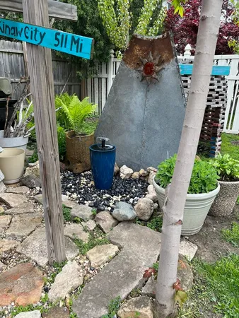 a view of a backyard with plants and patio