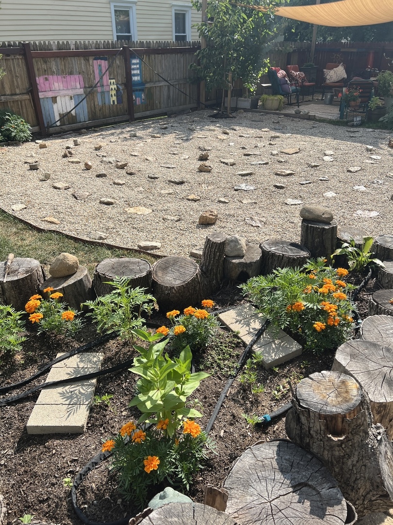 802 Paddock Avenue Ashton, IL 61006 - Photo 36 of 37 a bunch of flowers in front of a brick building