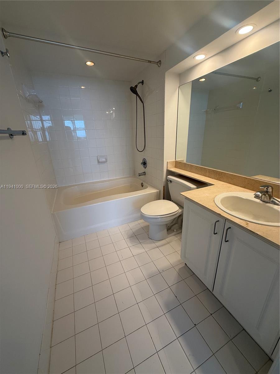 90 Alton Road, Unit 2803 Miami Beach, FL 33139 - Photo 6 of 21 a bathroom with a sink a toilet and shower