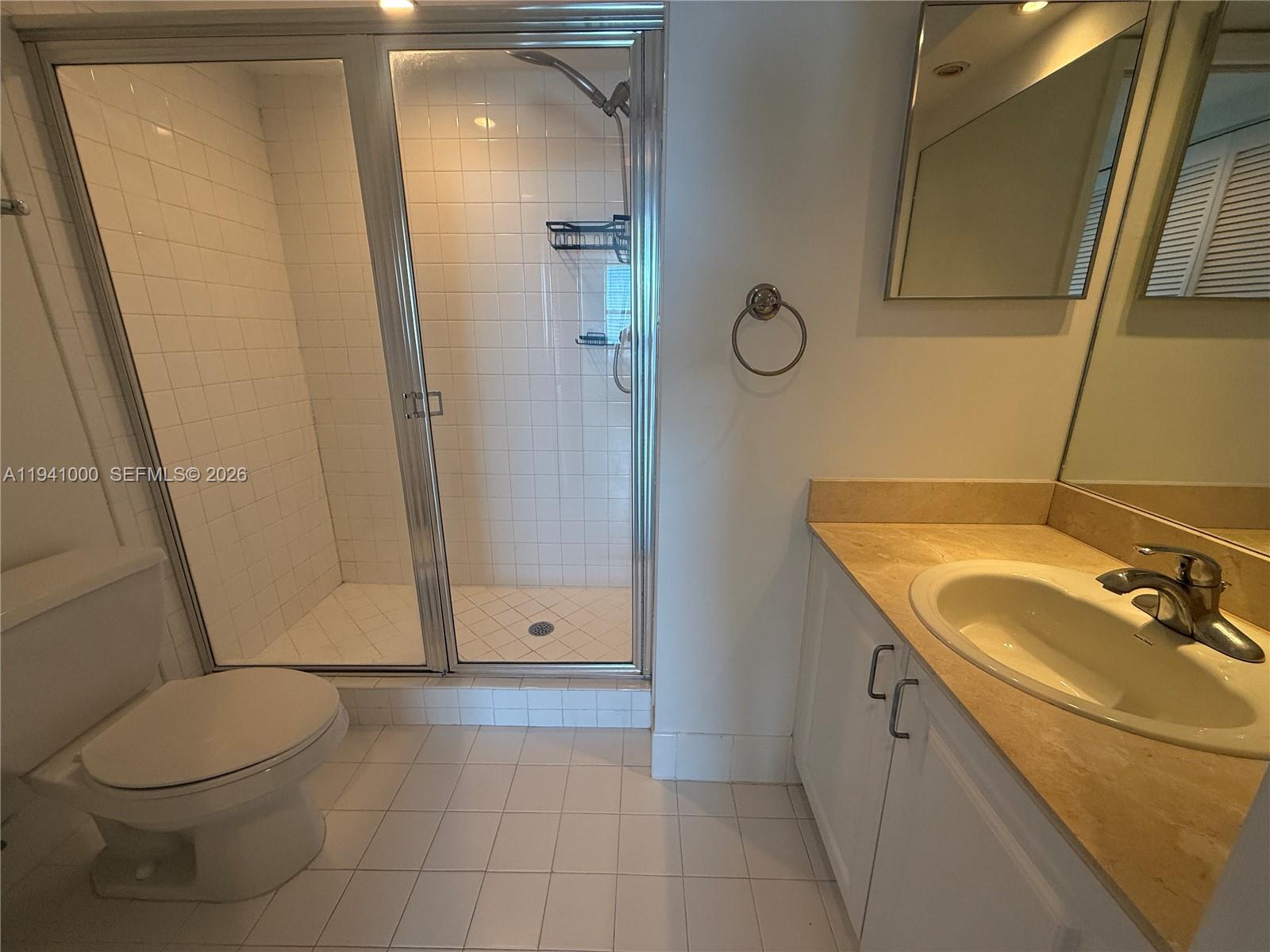 90 Alton Road, Unit 2803 Miami Beach, FL 33139 - Photo 8 of 21 a bathroom with a sink a toilet and shower