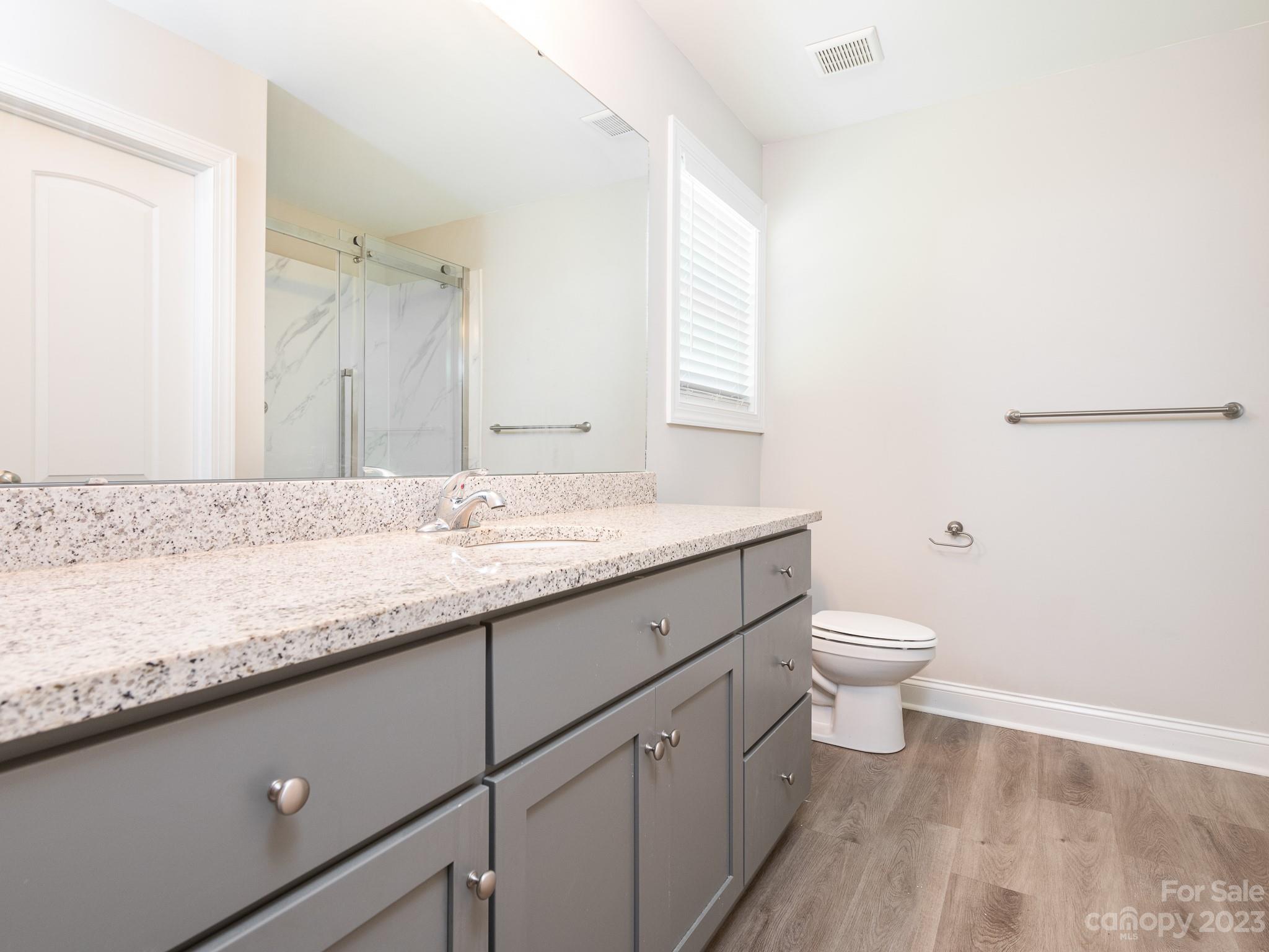 3095 Simmons Street Kannapolis, NC 28083 - Photo 11 of 21 a bathroom with a granite countertop sink a toilet and a mirror