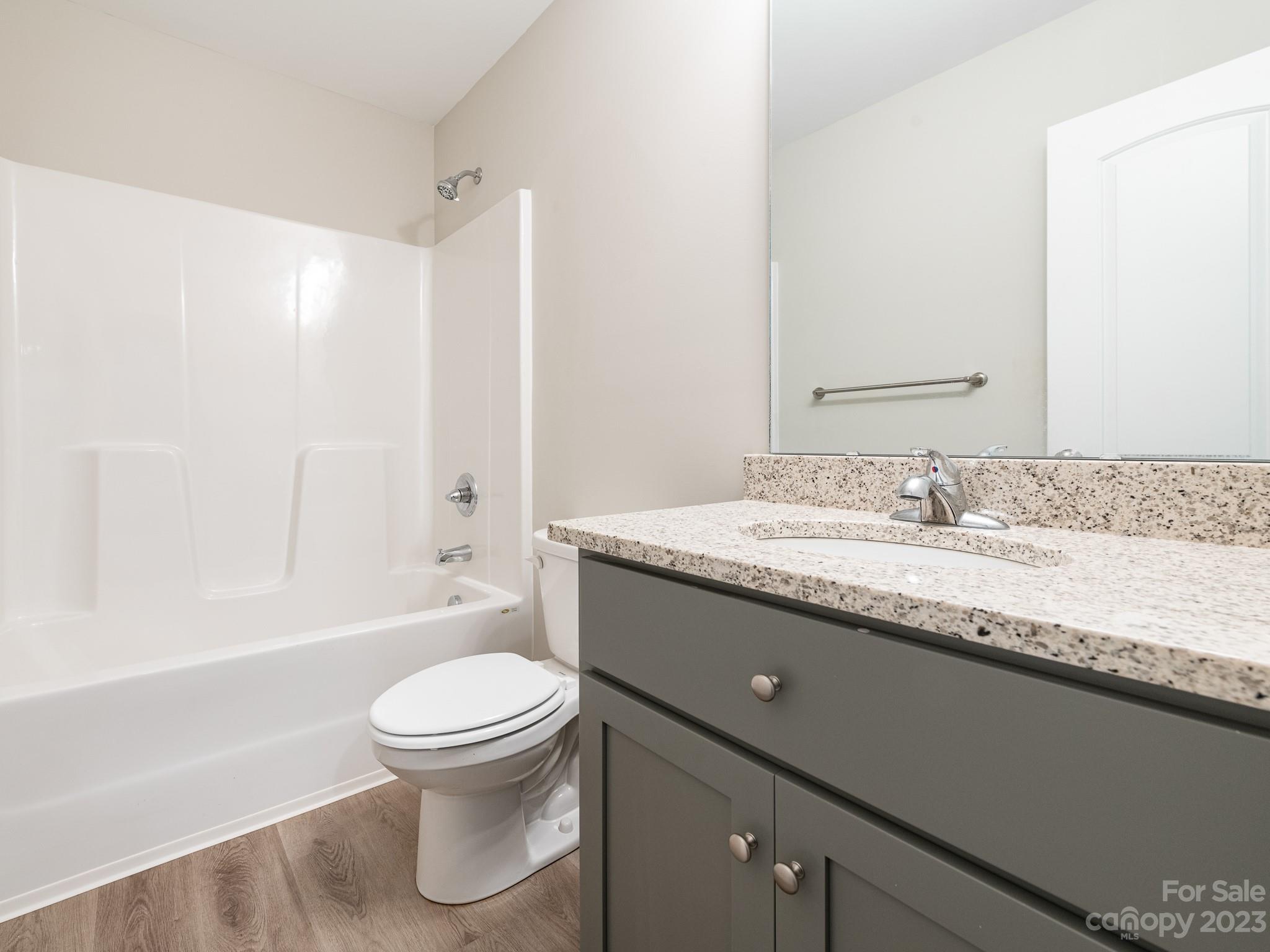 3095 Simmons Street Kannapolis, NC 28083 - Photo 17 of 21 a bathroom with a granite countertop toilet a sink and a bathtub