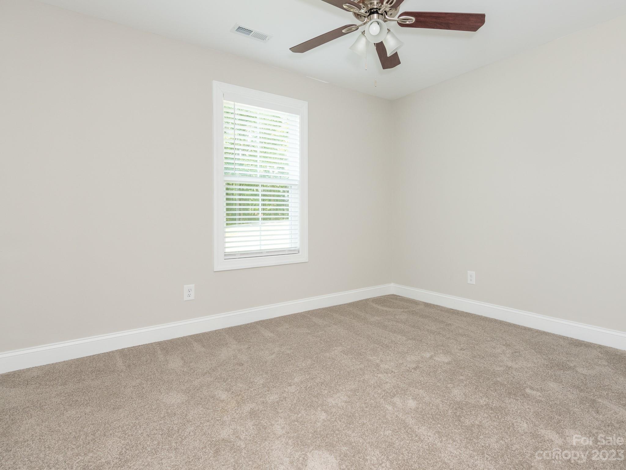 3095 Simmons Street Kannapolis, NC 28083 - Photo 18 of 21 an empty room with a window and a fan