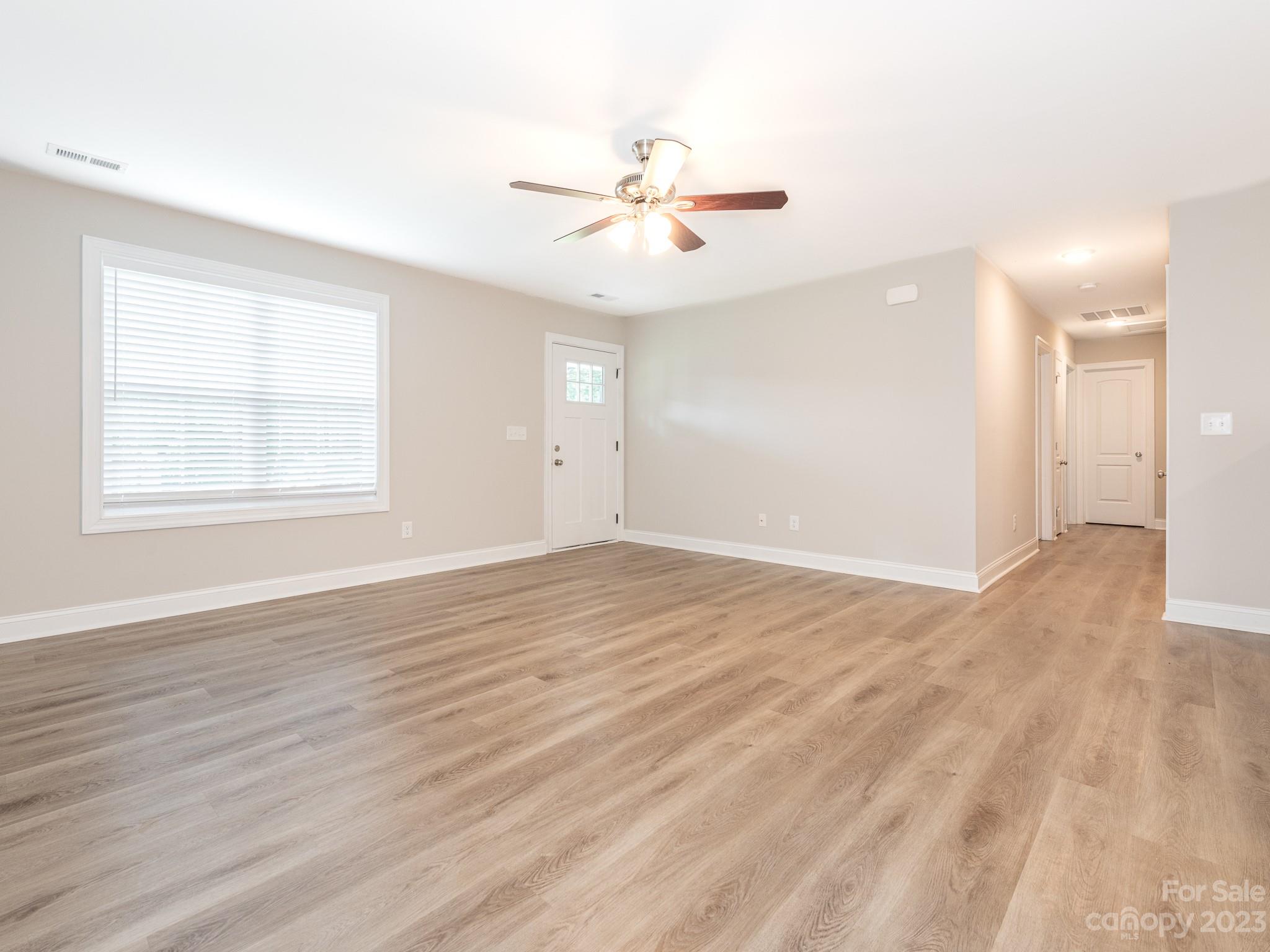 3095 Simmons Street Kannapolis, NC 28083 - Photo 3 of 21 wooden floor in an empty room with a window