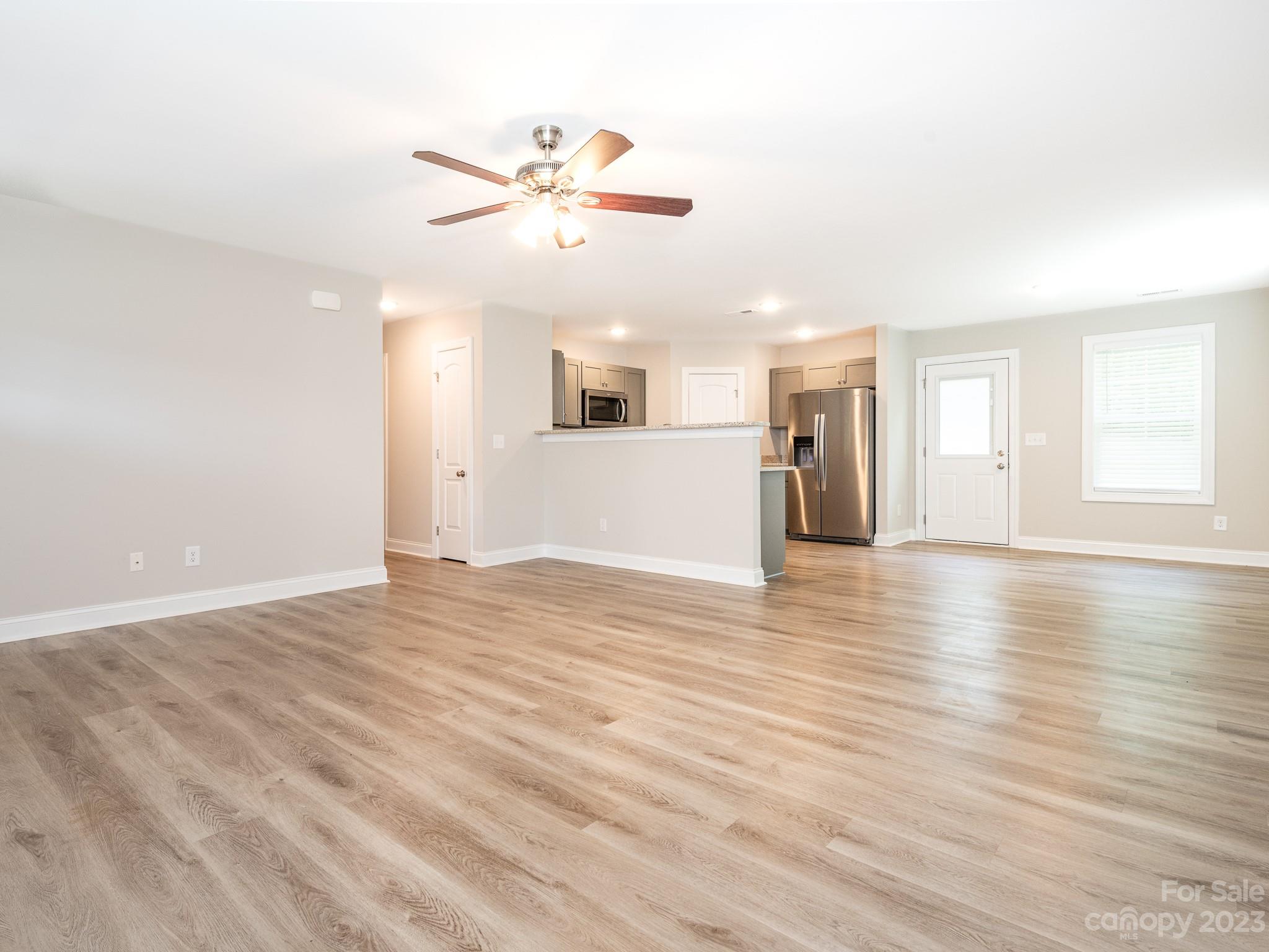 3095 Simmons Street Kannapolis, NC 28083 - Photo 4 of 21 a view of a livingroom with a ceiling fan window and wooden floor