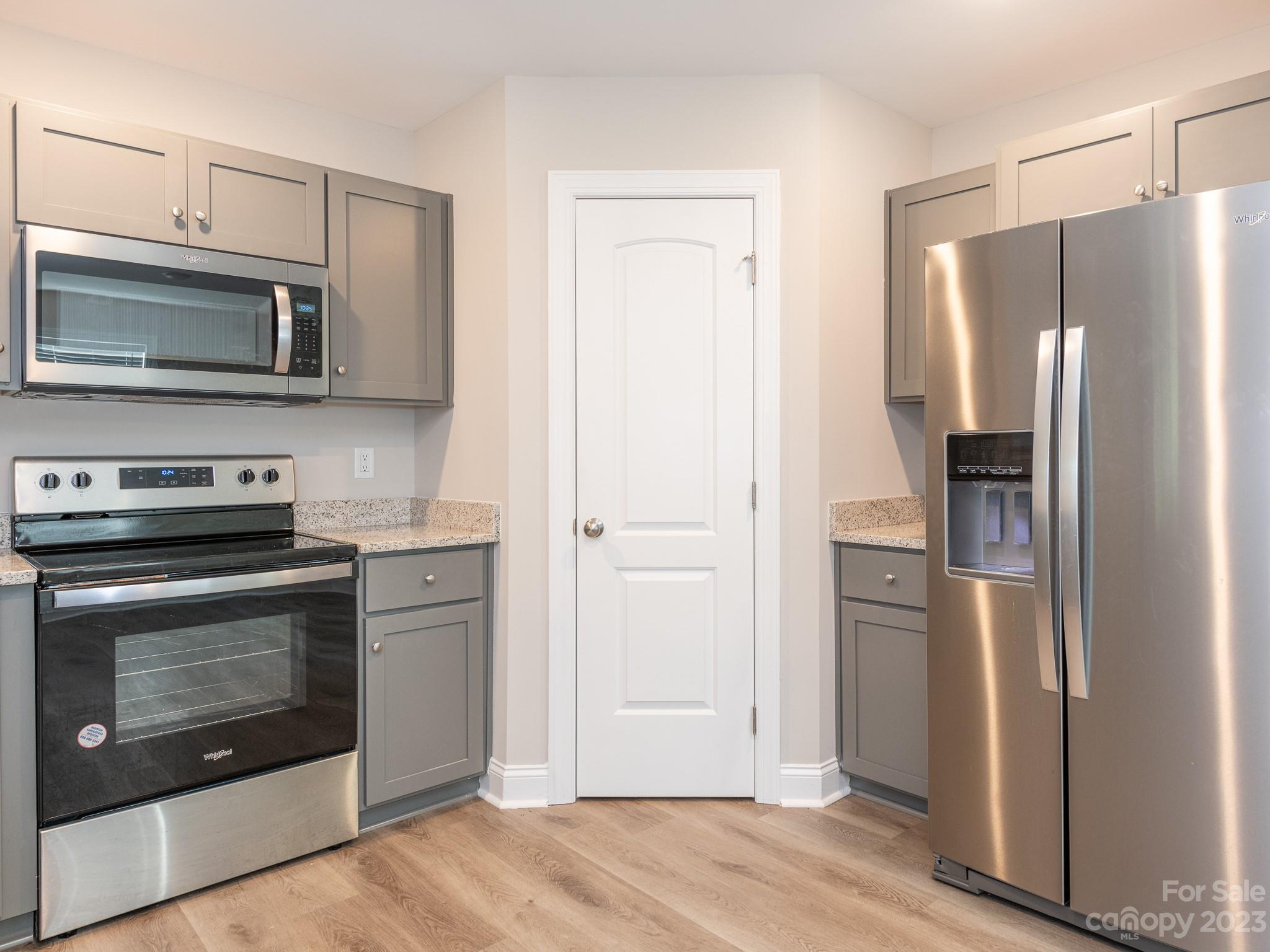 3095 Simmons Street Kannapolis, NC 28083 - Photo 8 of 21 a kitchen with stainless steel appliances granite countertop a refrigerator and a stove top oven