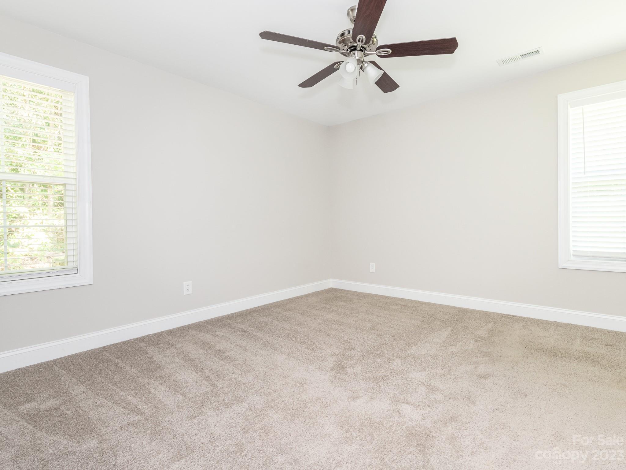 3095 Simmons Street Kannapolis, NC 28083 - Photo 9 of 21 an empty room with a window and a fan