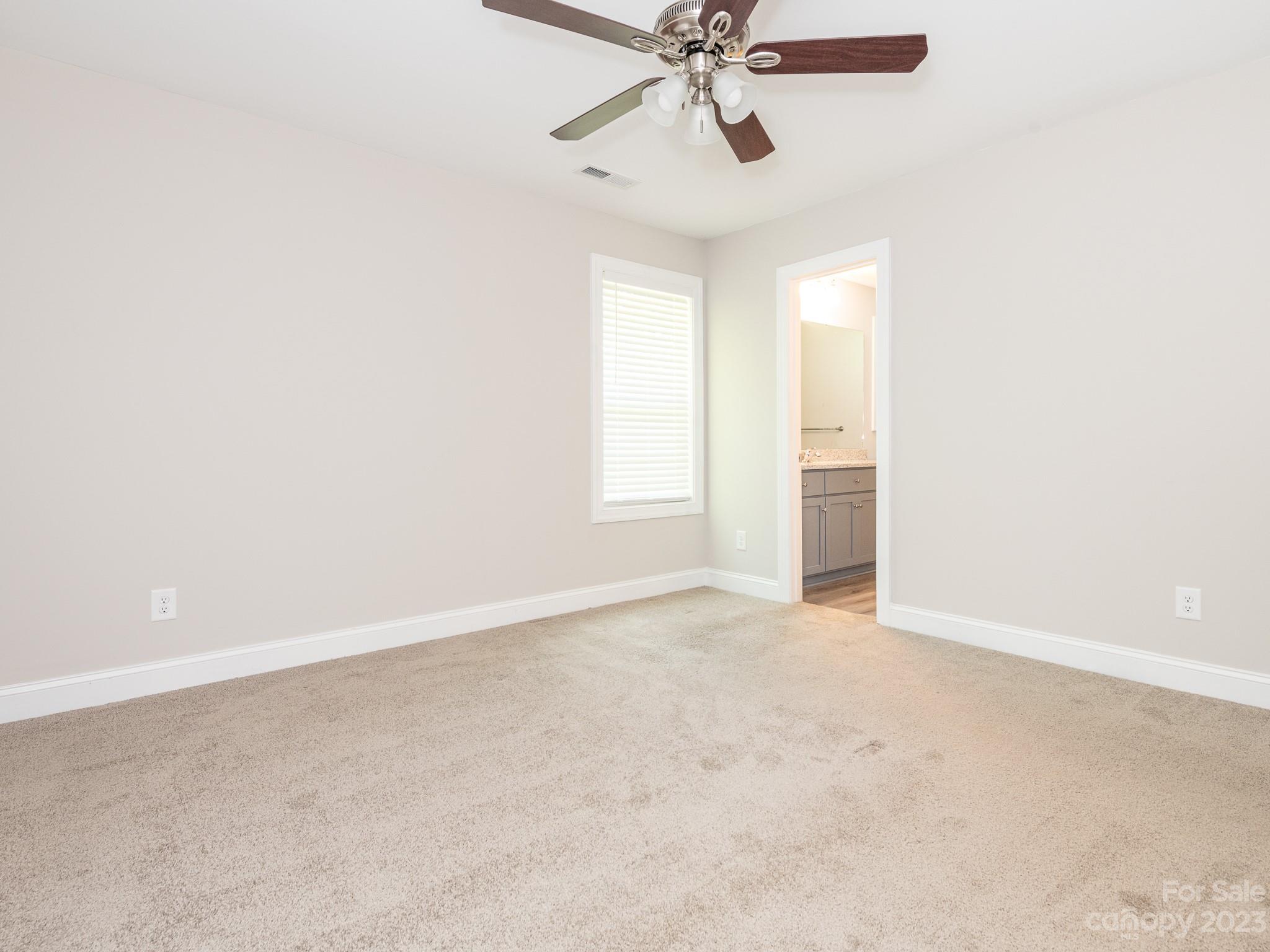 3095 Simmons Street Kannapolis, NC 28083 - Photo 10 of 21 an empty room with a window and a fan