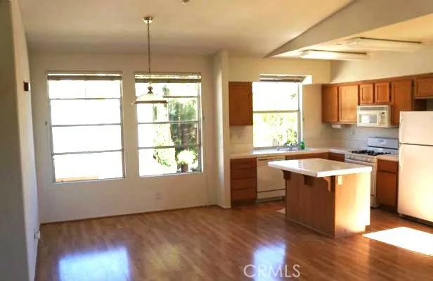 a kitchen with stainless steel appliances granite countertop a stove a sink and a window