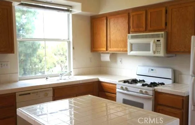 a kitchen with a sink stove top oven and cabinets